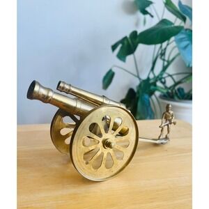 Vintage brass cannon display with soldier